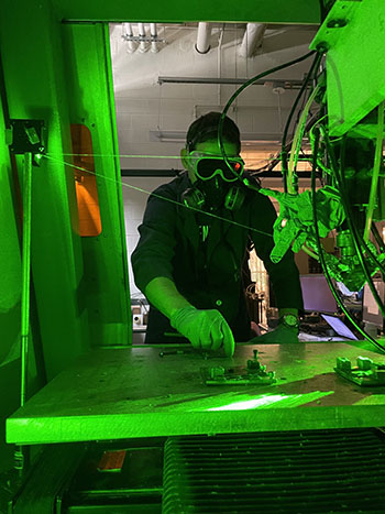 Metin Kayitmazbatir working on the DMD technology in Jyoti Mazumder's lab.