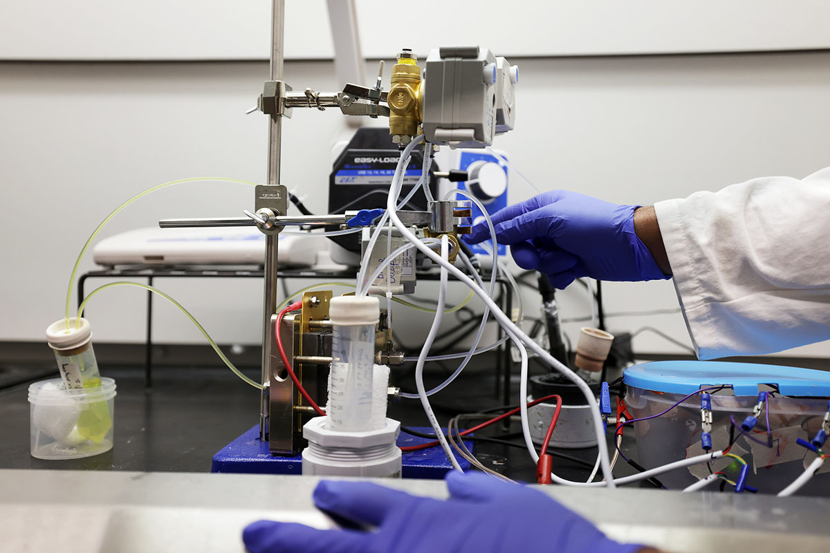 Siddhant Singh, mechanical engineering PhD student, demonstrates the work he's been doing with an electrochemical flow cell designed to desalinate water for David Kwabi, mechanical engineering assistant professor, at the Battery Lab.