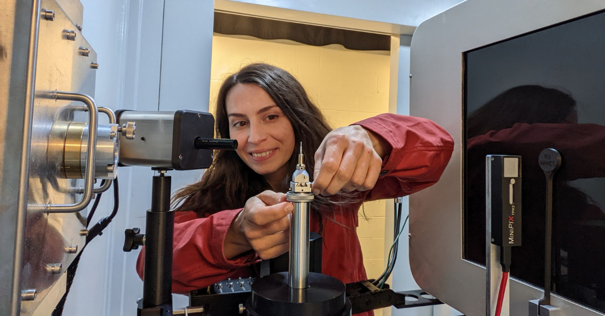 Assistant Professor Ashley Bucsek adjusting a new lab microscope.