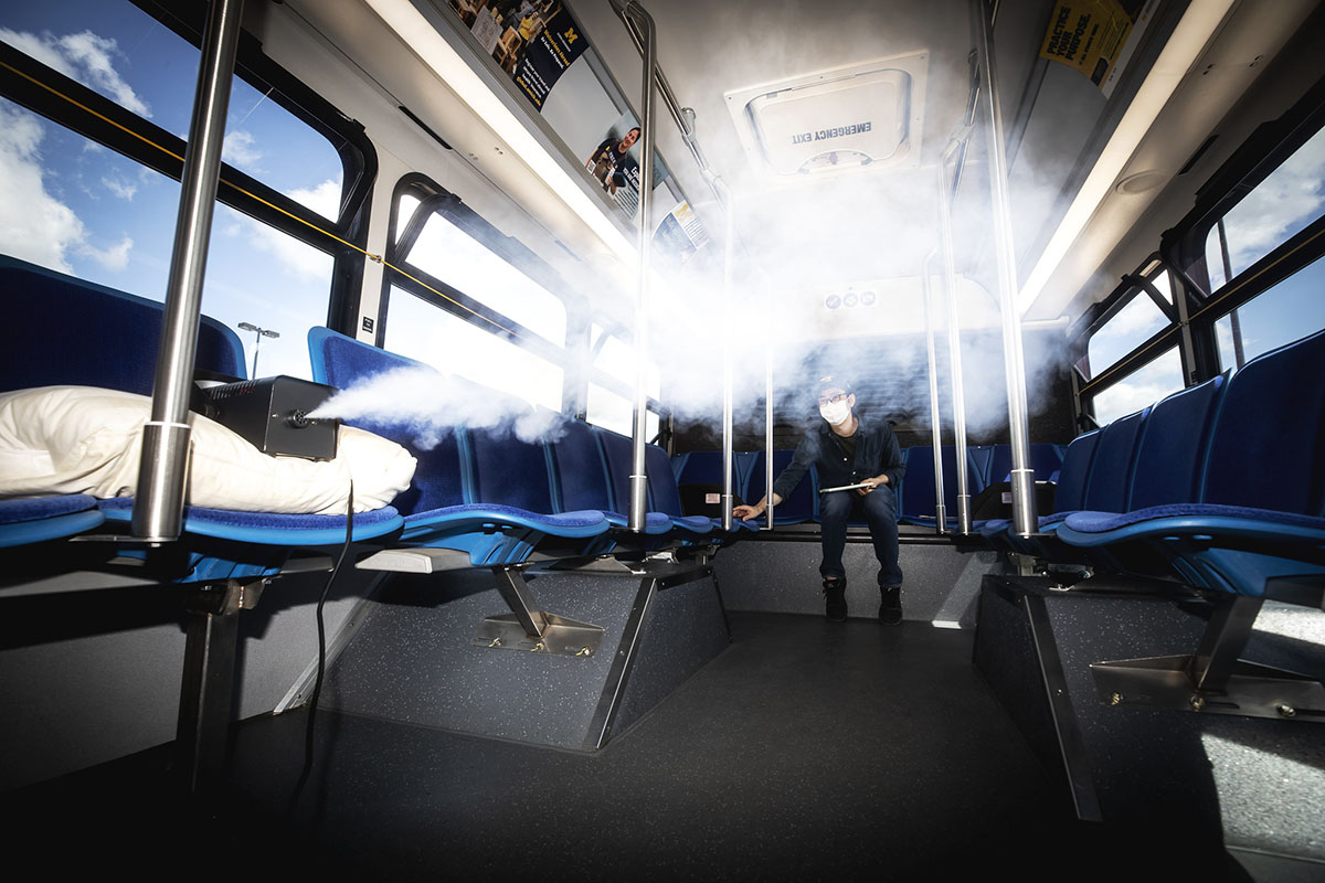 Kwang Hee Yoo, ME Researcher, measures the flow of aerosols in a University of Michigan blue bus in Ann Arbor, MI on June 24, 2020. Photo: Joseph Xu/Michigan Engineering, Communications & Marketing