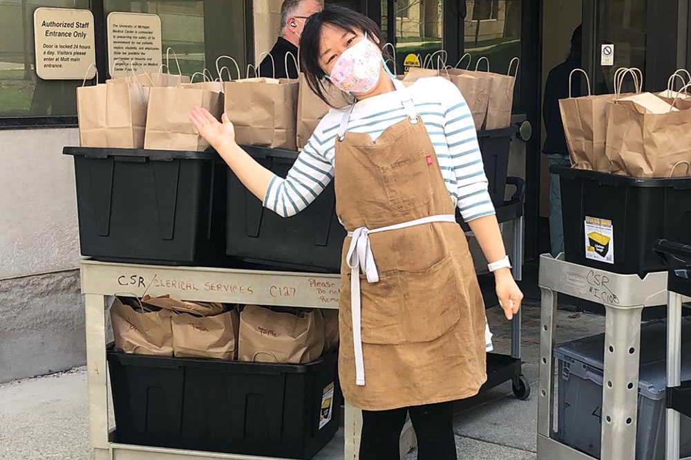 Miss Kim chef and managing partner Ji Hye Kim with prepared food deliveries. Photo courtesy of Miss Kim.