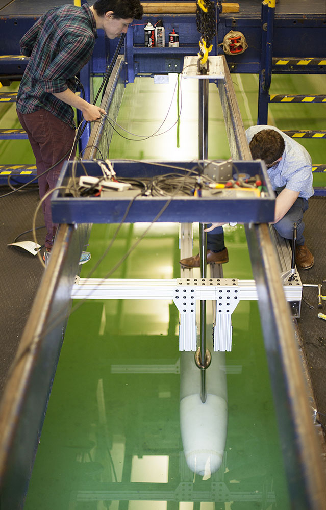 A towed axisymmetric model is tested in the U-M Marine Hydrodynamics Laboratory to determine the amount of skin friction reduction achieved through application of Super Hydrophobic Coatings on its surface.