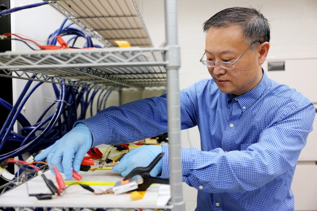 University of Michigan professor of Mechanical Engineering, Wei Lu, conducts research on batteries in a lab.