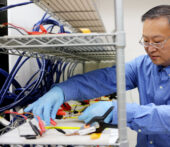 University of Michigan professor of Mechanical Engineering, Wei Lu, conducts research on batteries in a lab.