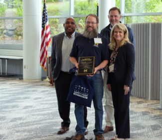 Charlie Bradley is presented a plaque for his Excellence in Research Safety Award.